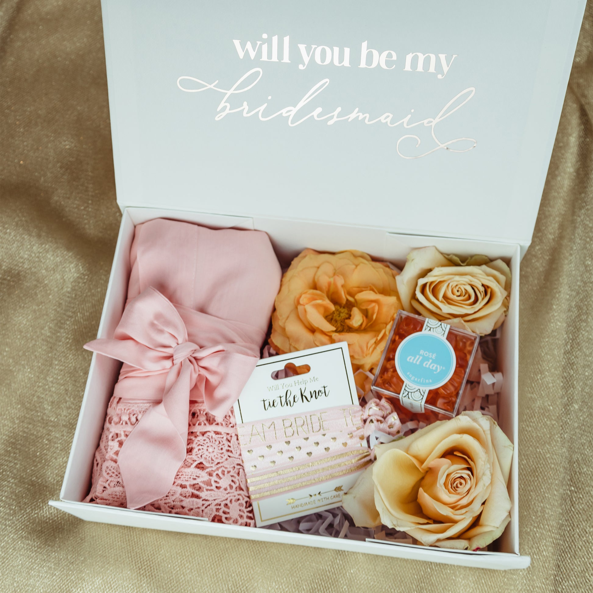 Propose to your Bridal Party with a Cute Gift Box Personalized with their Names and Lots of Goodies Inside like a Soft Getting Ready Robe and Some Hair Accessories to Help You Tie the Knot