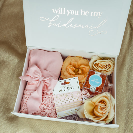 Propose to your Bridal Party with a Cute Gift Box Personalized with their Names and Lots of Goodies Inside like a Soft Getting Ready Robe and Some Hair Accessories to Help You Tie the Knot