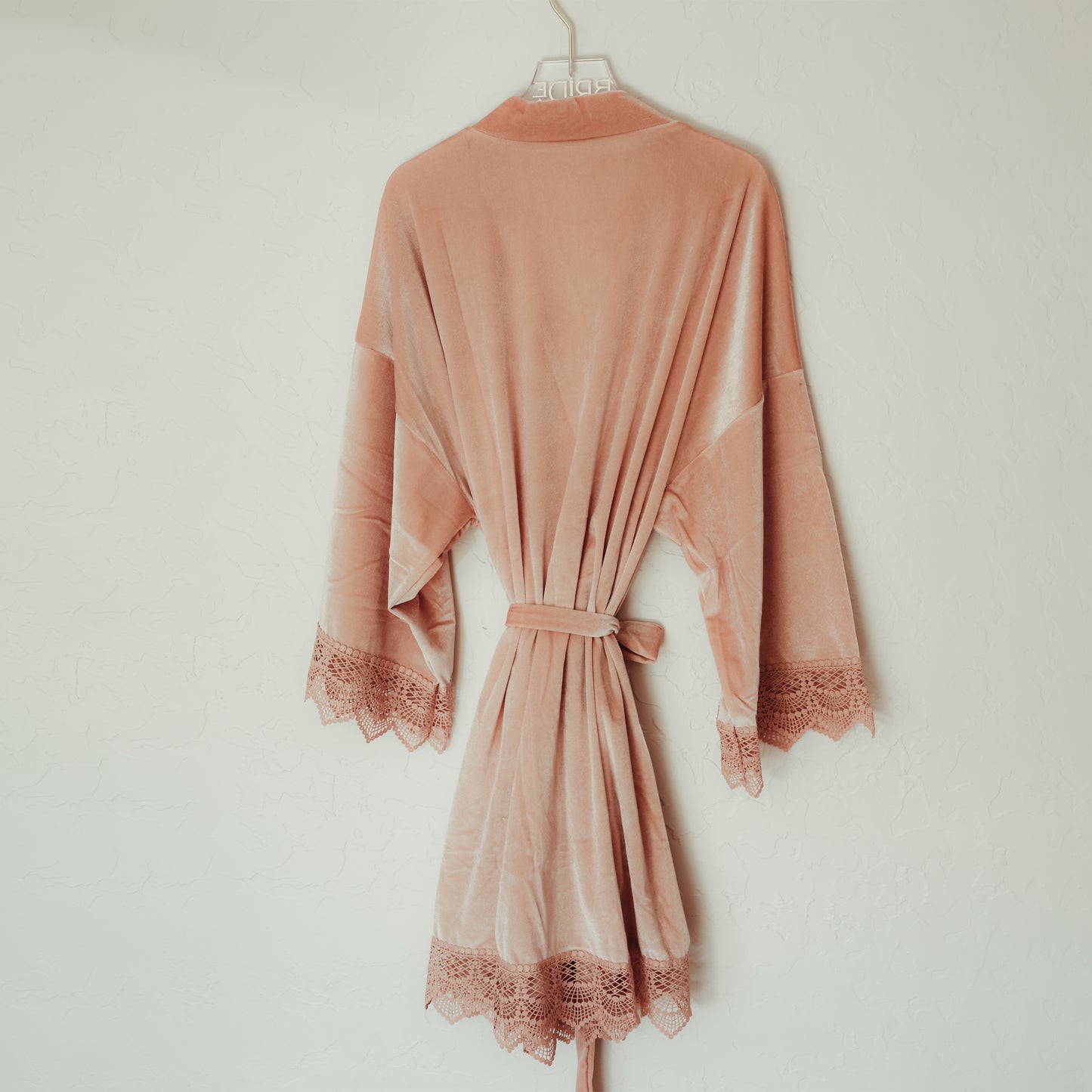 Sophisticated velvet robe with lace sleeve accents, perfect for bridesmaids to wear while getting ready
