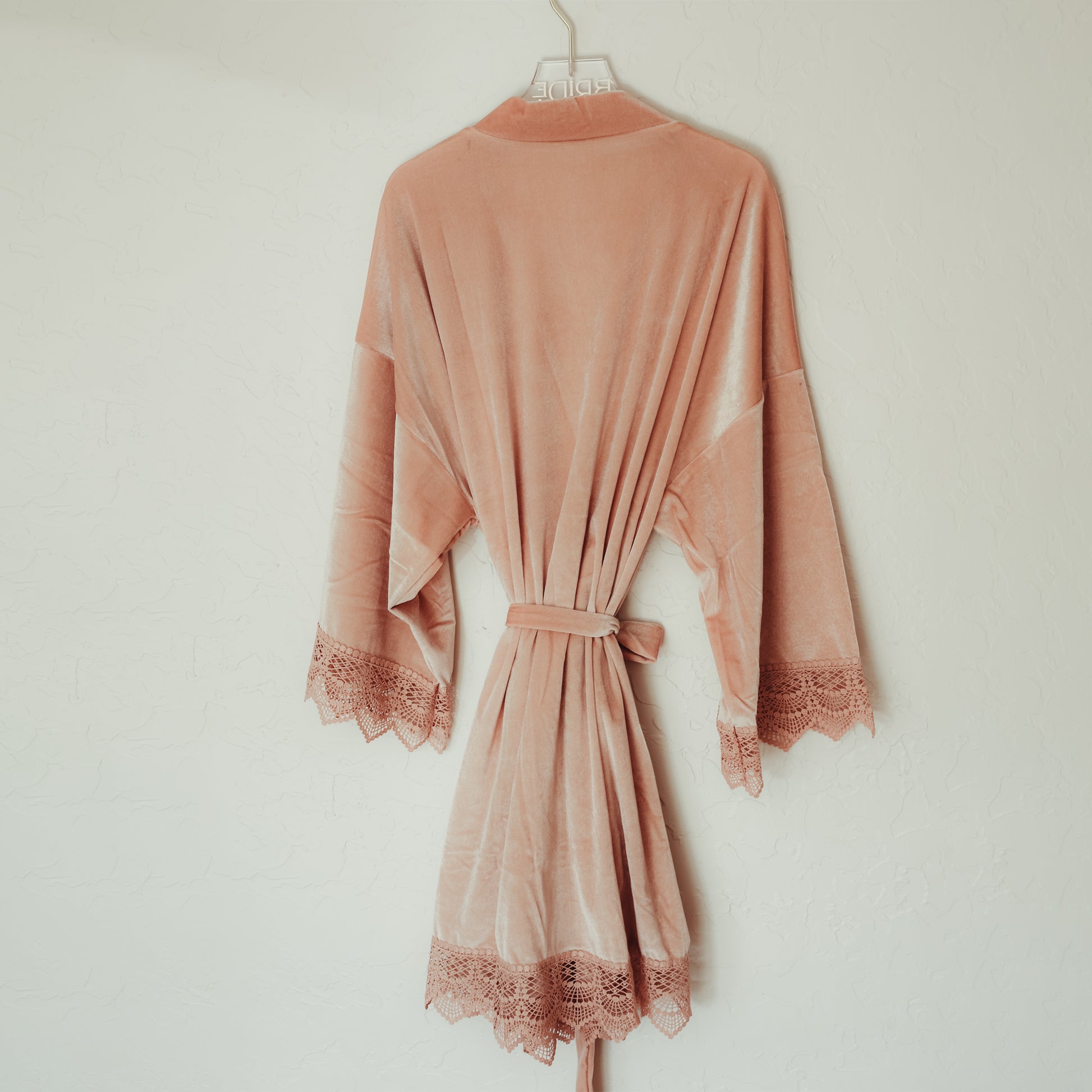 Sophisticated velvet robe with lace sleeve accents, perfect for bridesmaids to wear while getting ready