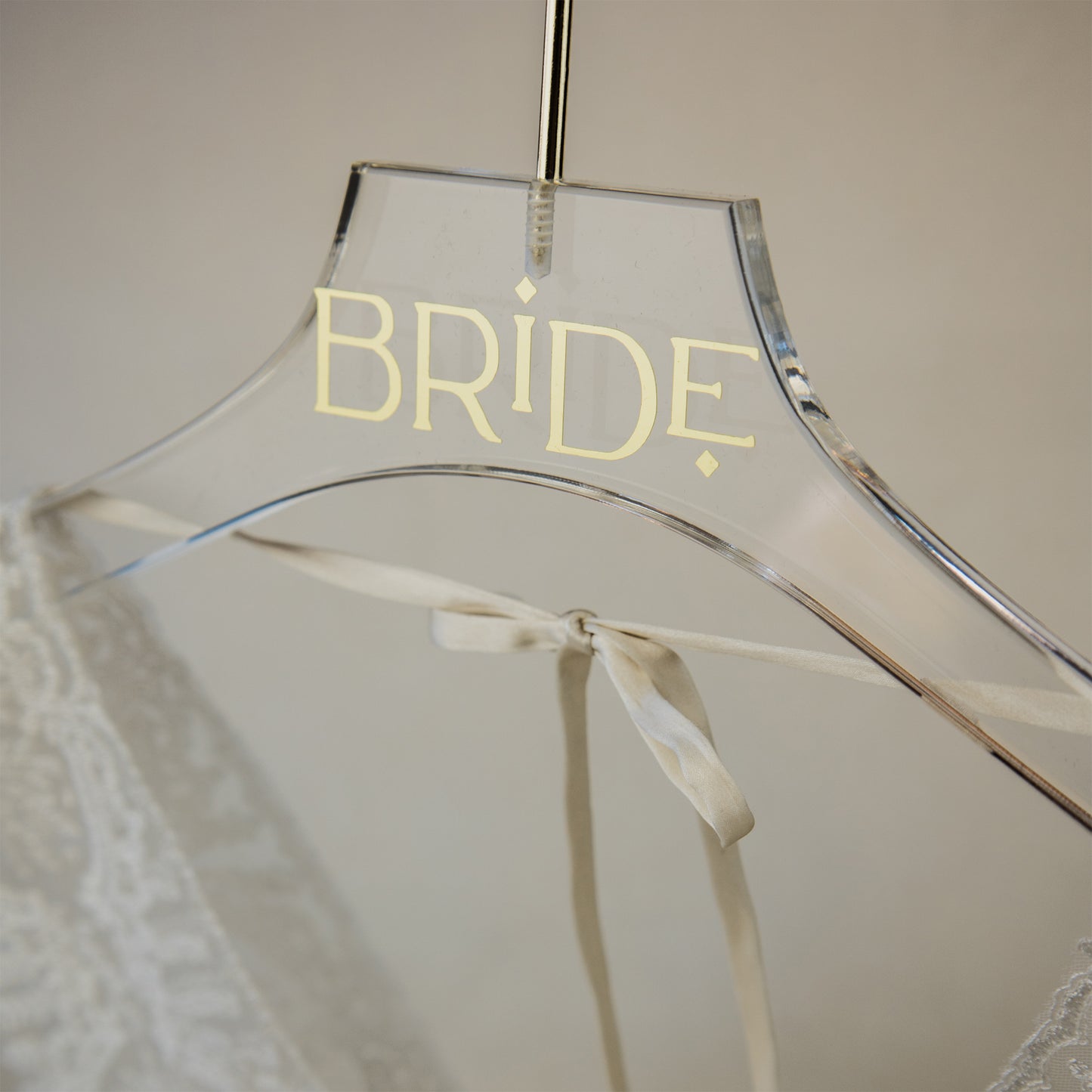 Gold text on an acrylic wedding dress hanger, a luxurious touch for the bride's special day.