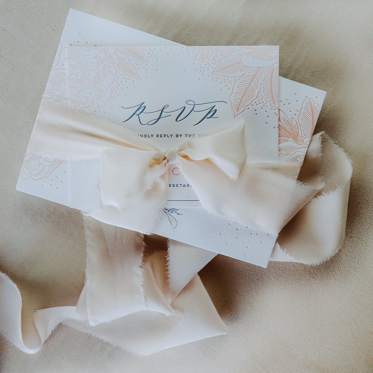 Silk ribbon used for tying wedding invitations in a pretty bow