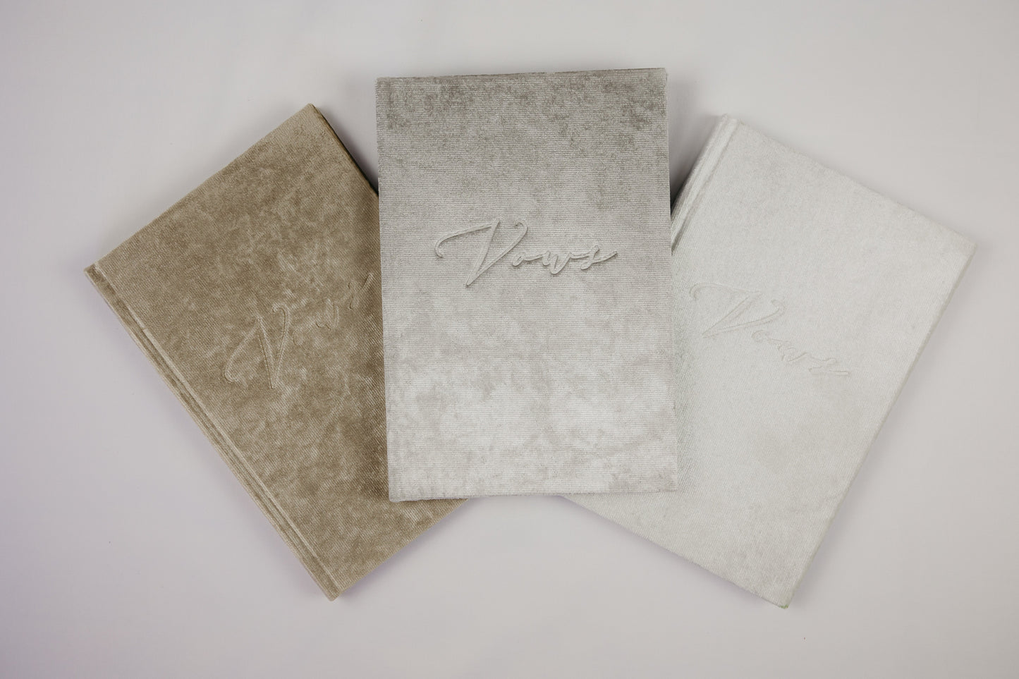 Embossed 'vows' on a soft velvet cover, vow book in white, silver, or champagne, with decorative ribbon spine tie