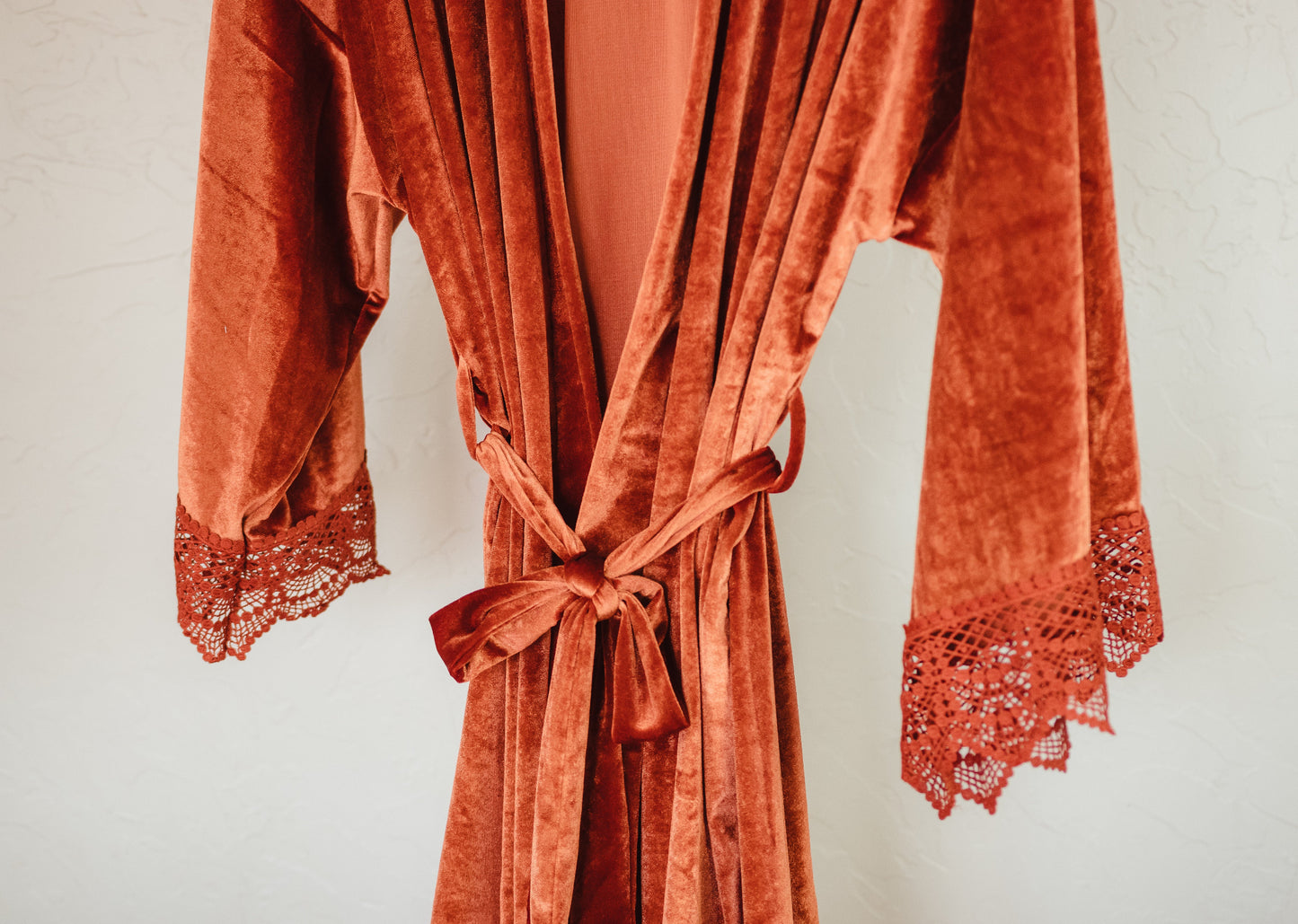 A sumptuous velvet robe with lace accents, perfect for your bridal party to feel pampered and special
