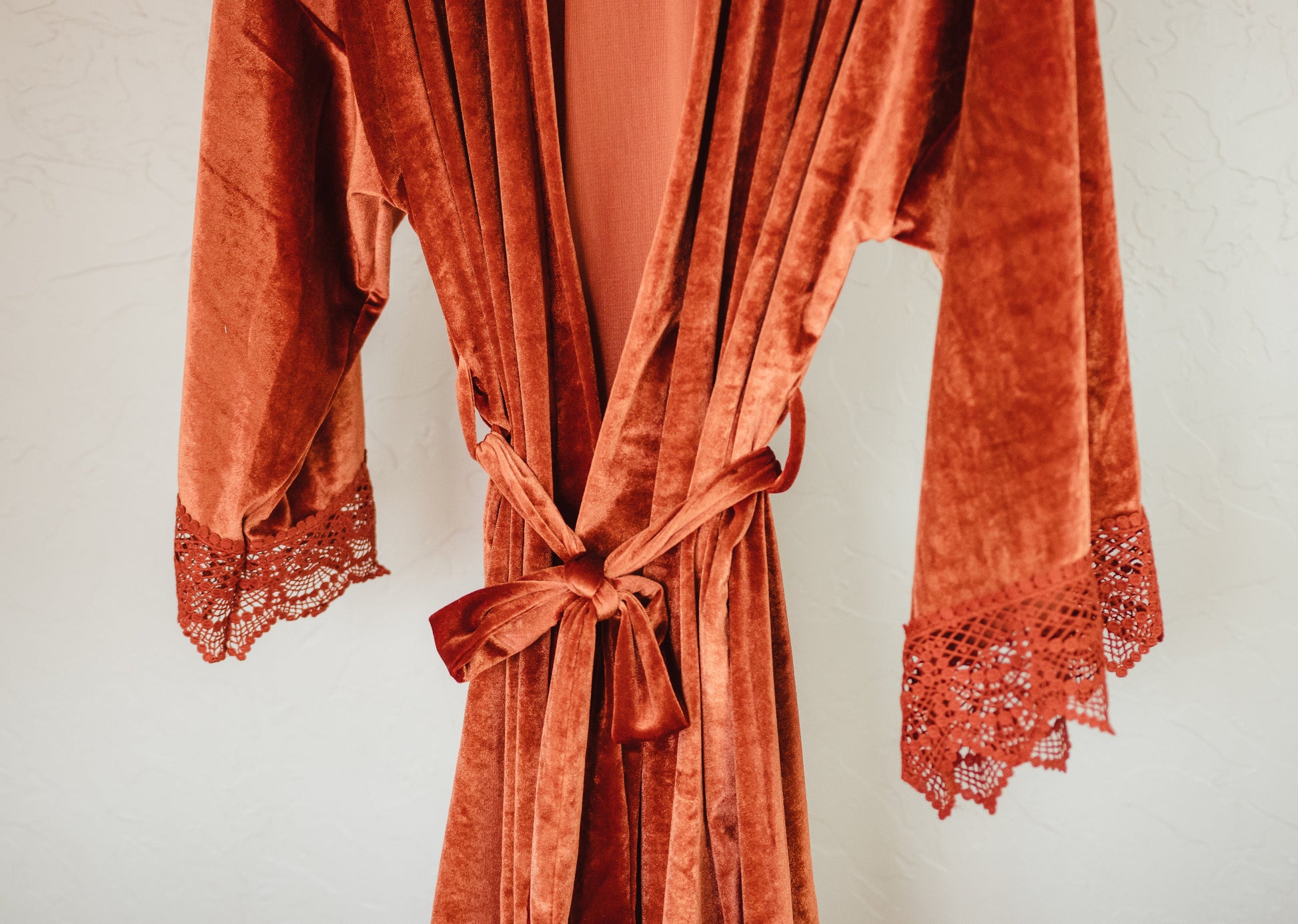 A sumptuous velvet robe with lace accents, perfect for your bridal party to feel pampered and special