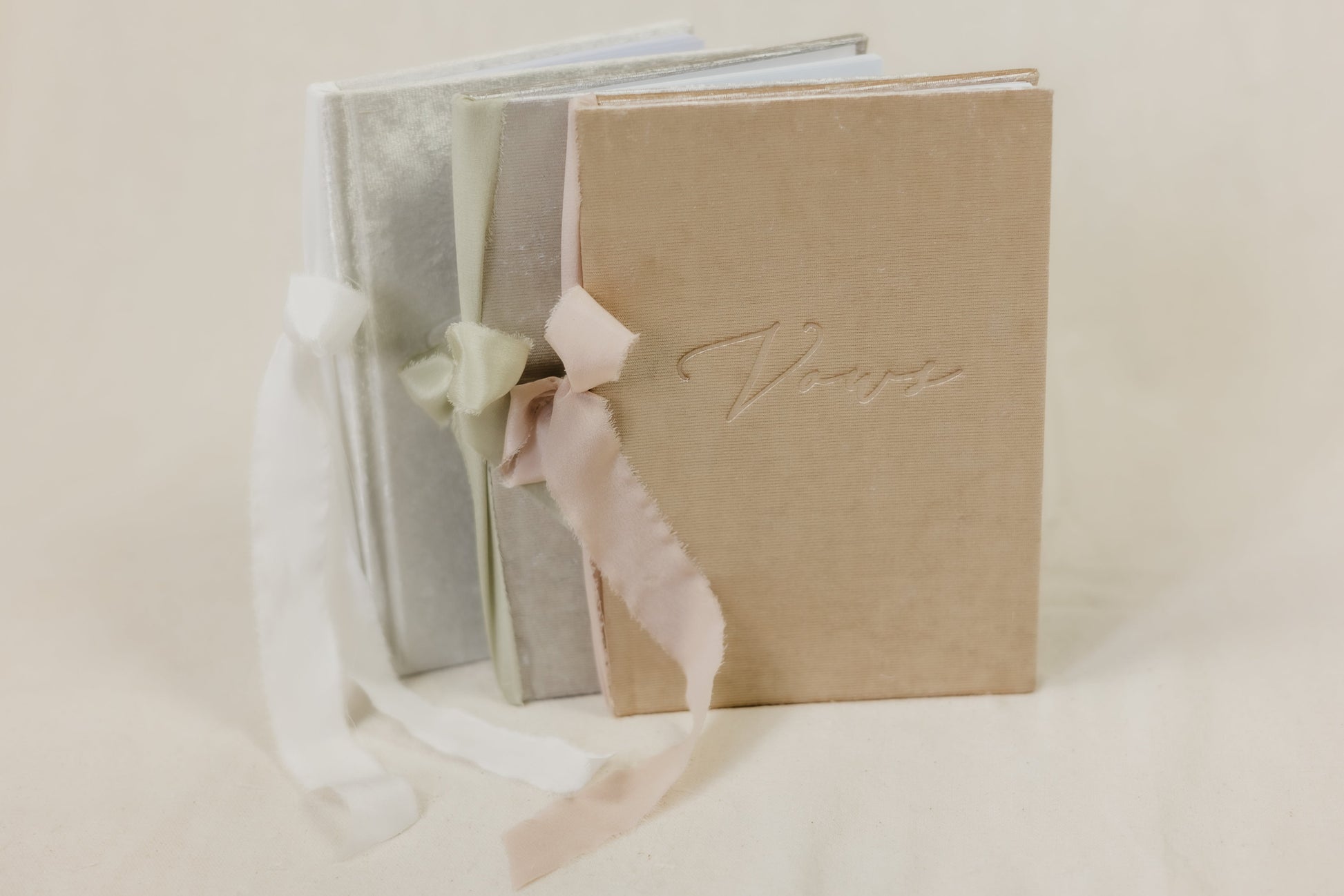 Vow books with velvet cover, 'vows' embossed, and ribbon tie, available in white, silver, champagne velvet and various ribbon colors
