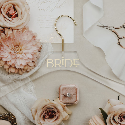 Acrylic wedding dress hanger, personalized with the bride's name in gold, adding a special touch to her day