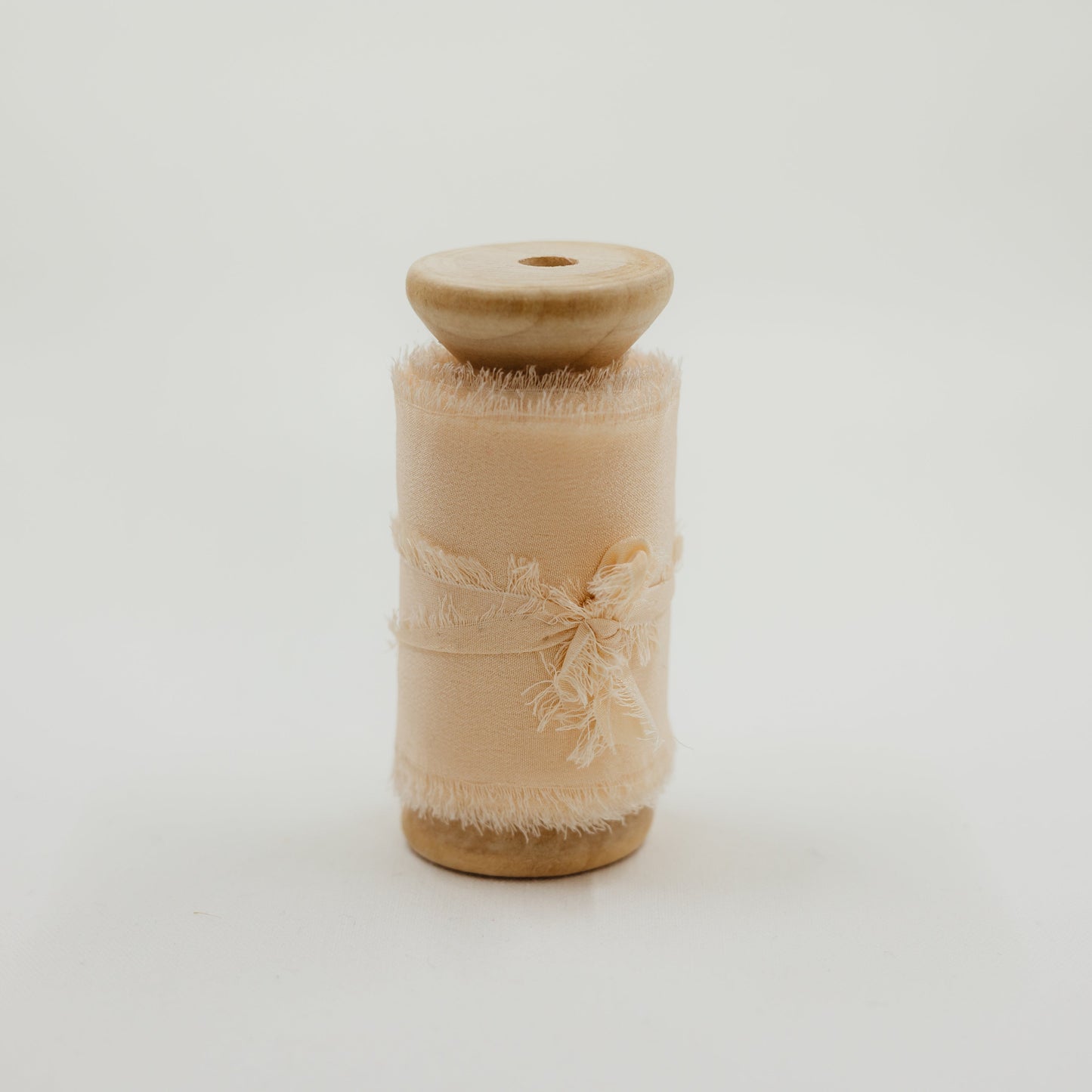 Handmade silk ribbon with a raw edge, adding a soft, organic touch to wedding flat lay compositions